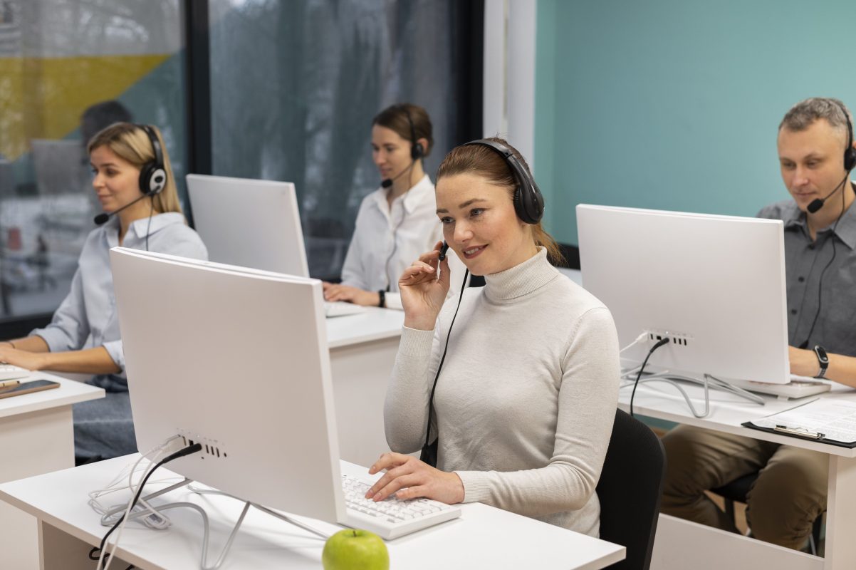 Colleagues with headphones working call center office