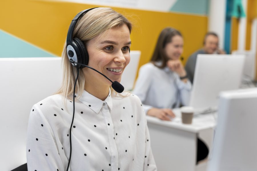 Blond woman working call center with headphones computer