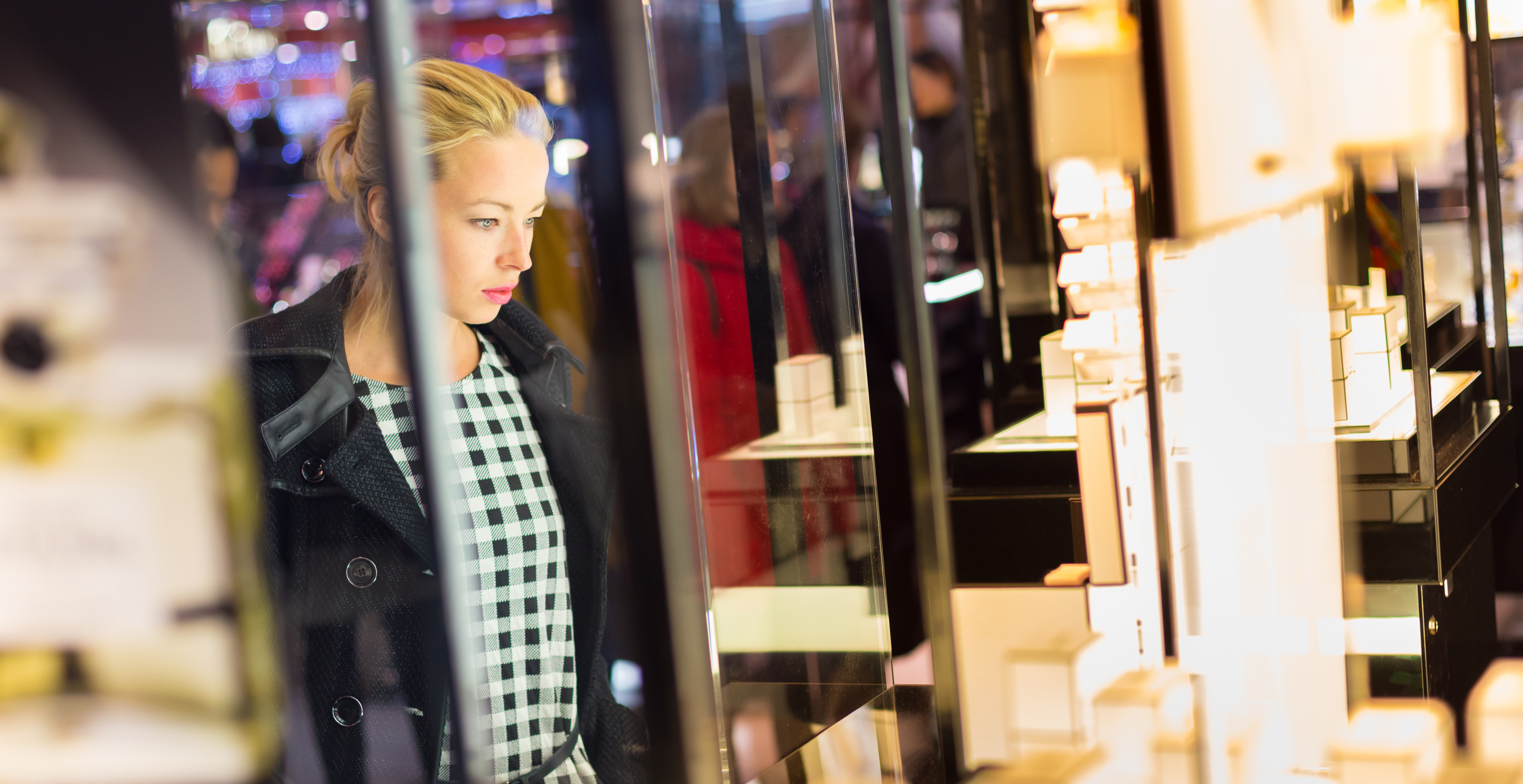 Beautiful woman looking perfume store