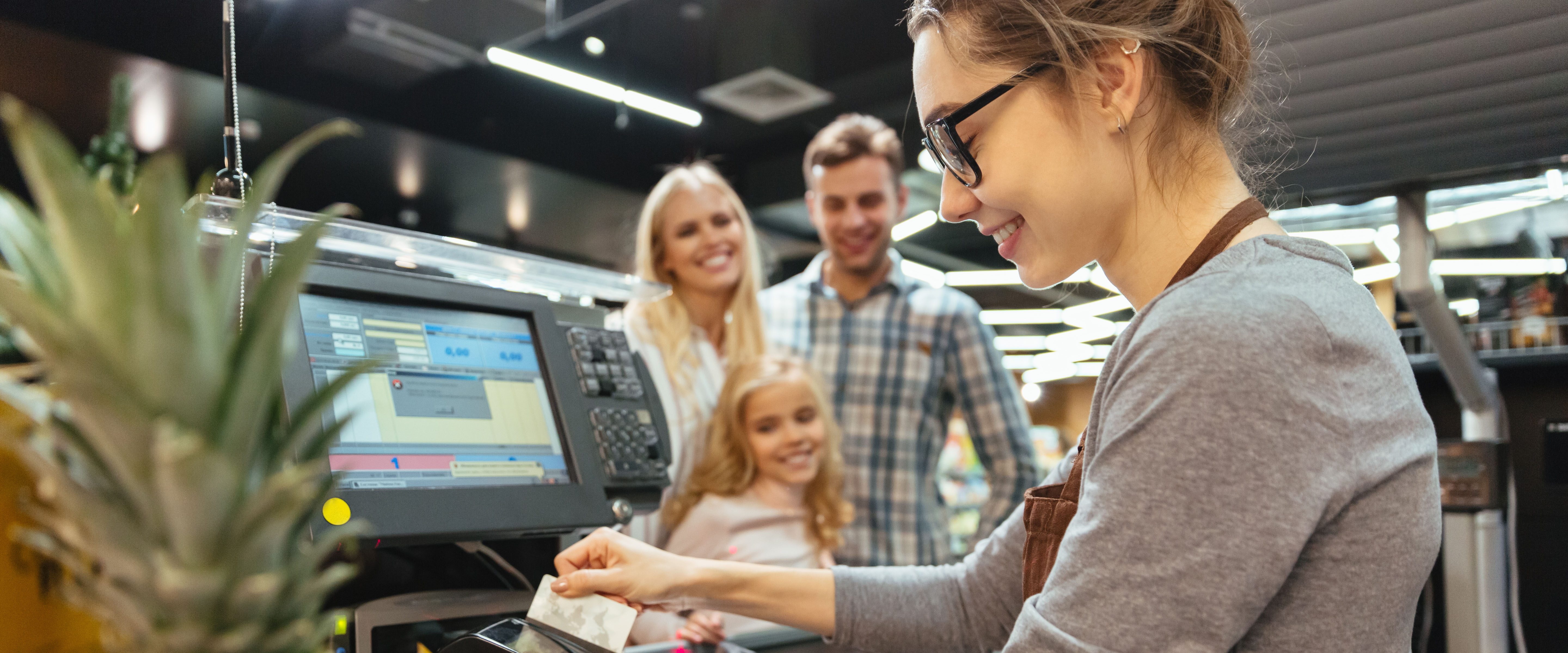 Happy family paying their groceries copy