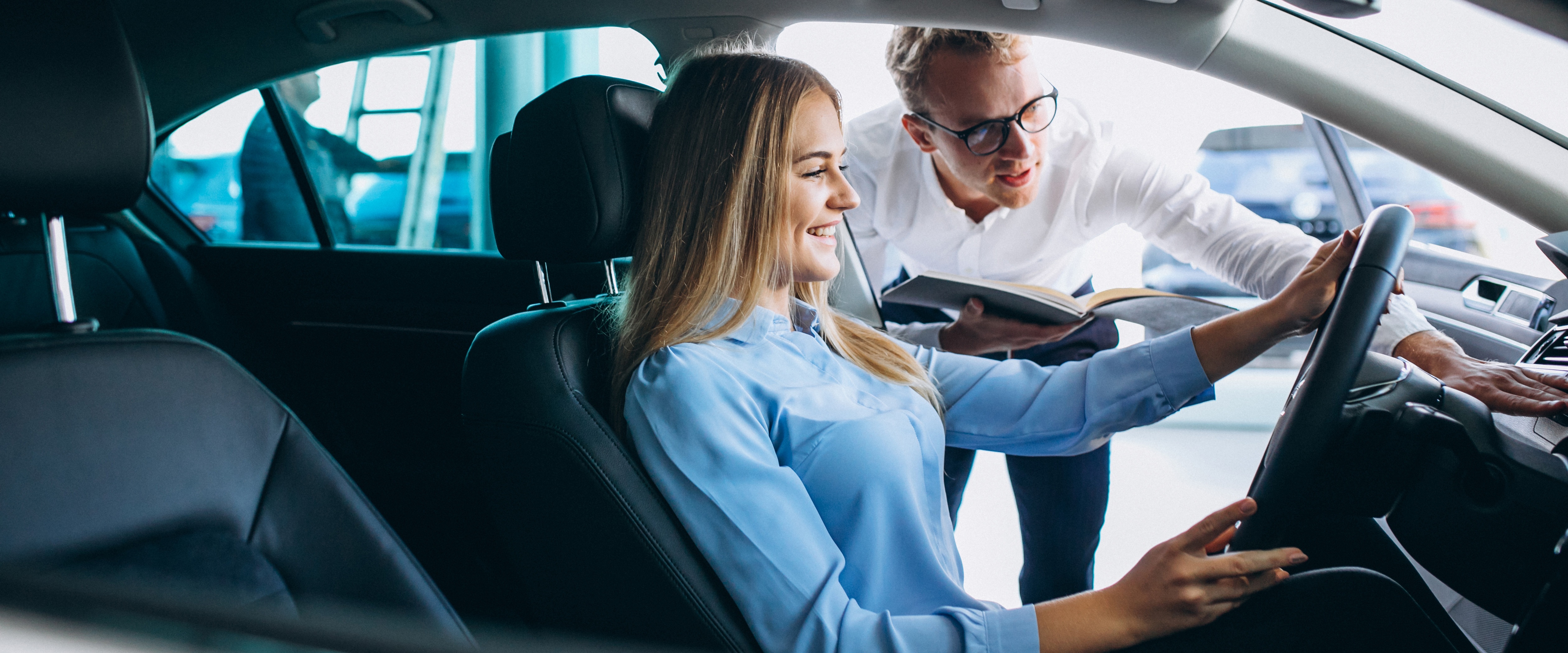 Young woman testing car from car showroom 1 copy